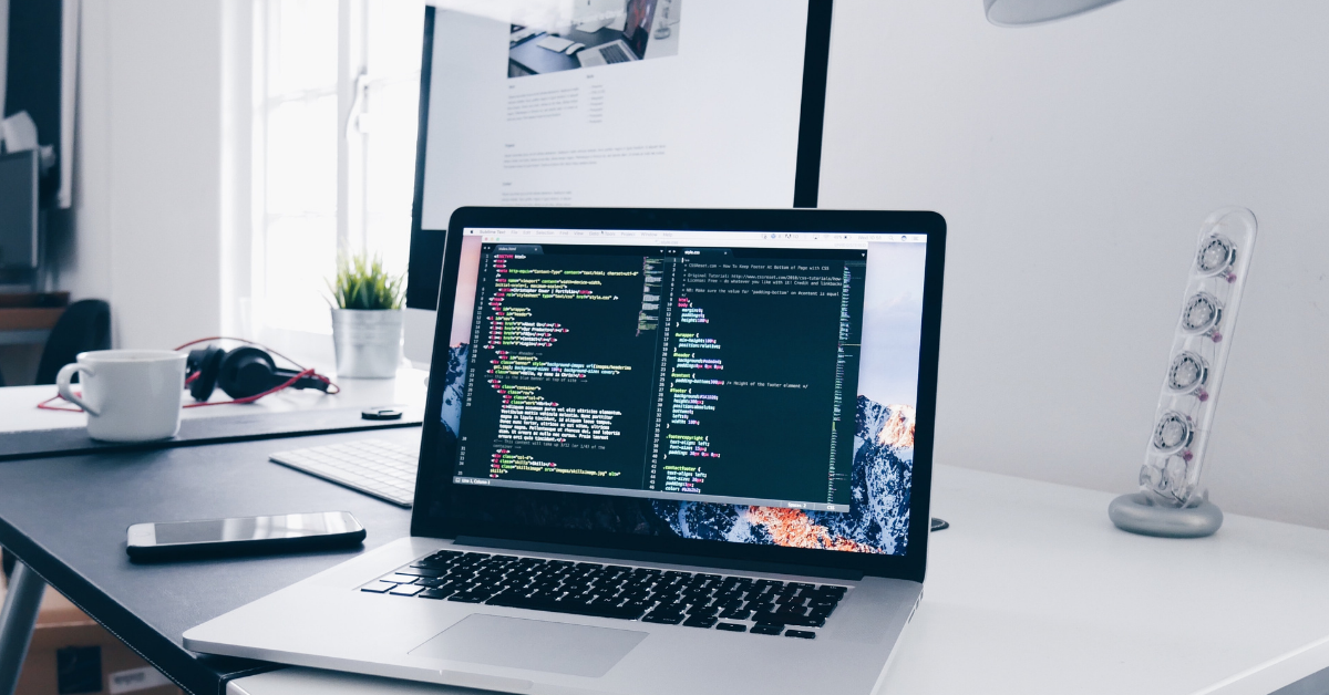 Laptop on table with coding on screen